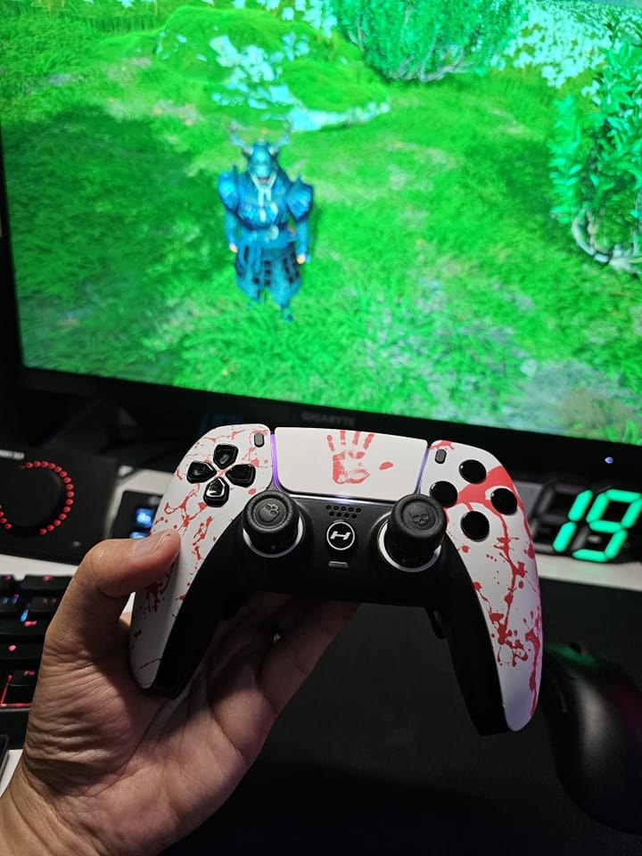 Customer holding a white and red HYPR DualSense controller while gaming